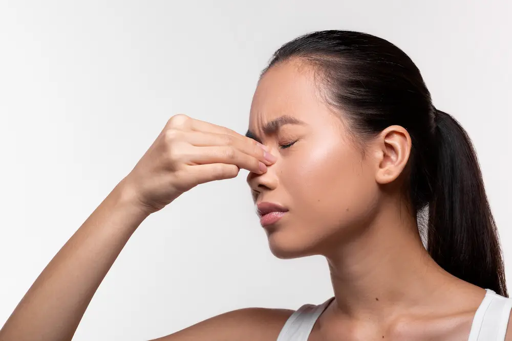 Woman massaging their nose bridge close up view