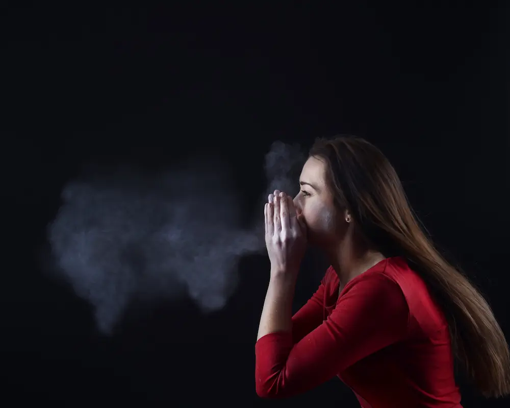 Picture of young woman sneezing