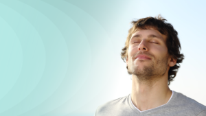 Man tilting his head up with eyes closed being happy